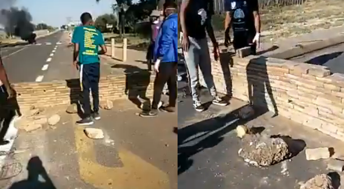 Video Group of youths build a wall along a road in South Africa