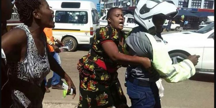 Zimbabwe police beaten by civilians