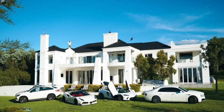 Cassper Nyovest flaunts white fleet of cars, while standing on top of his mansion