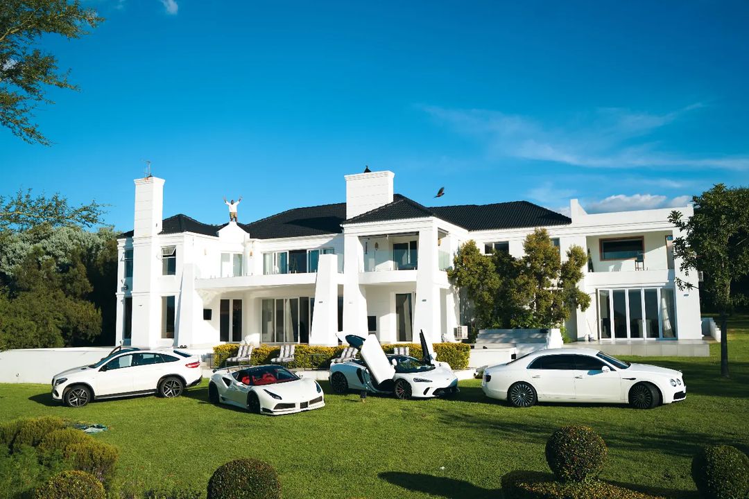 Cassper Nyovest flaunts white fleet of cars, while standing on top of his mansion