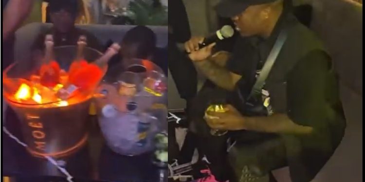 Andile Mpisane performs sitting down in a club