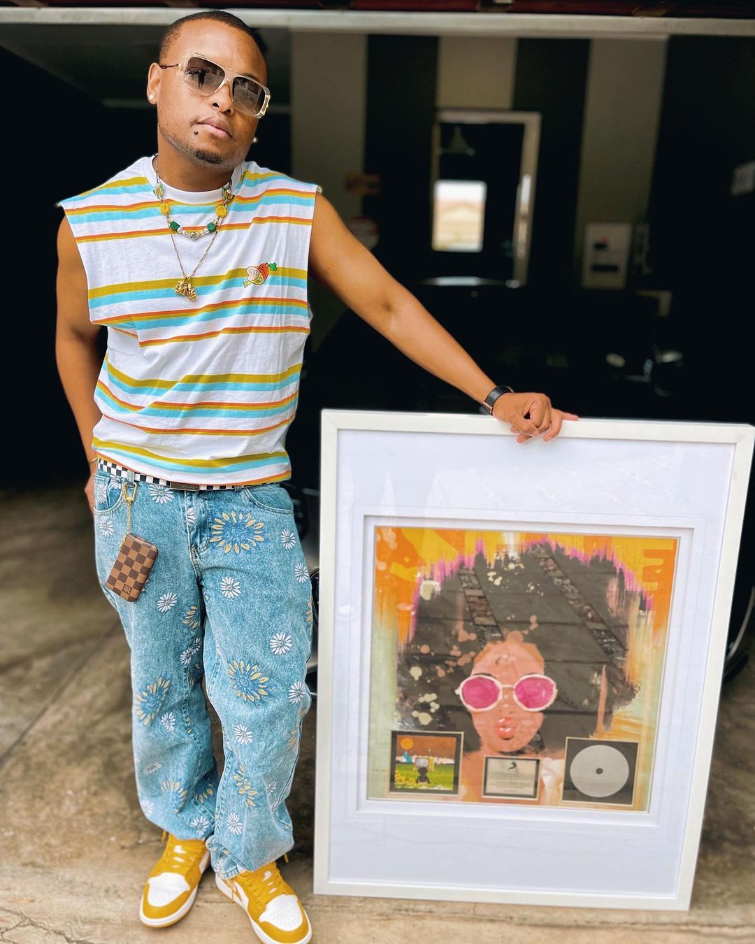 K.O holding his Platinum Plaque for SETE